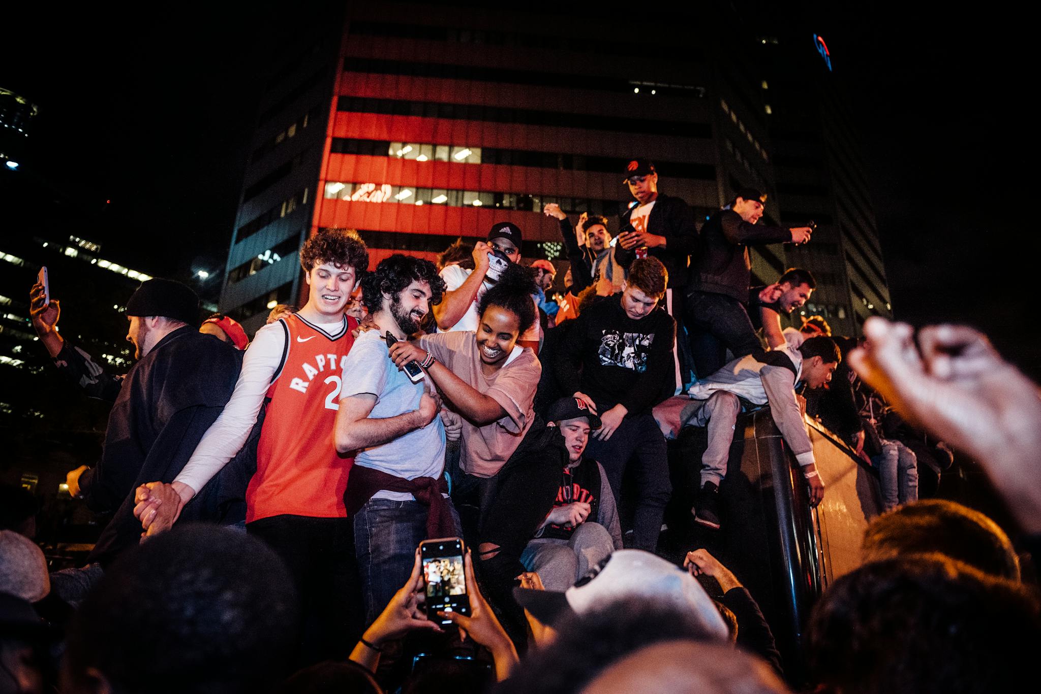 Energetic crowd celebrating a night event in the city with joyful togetherness.